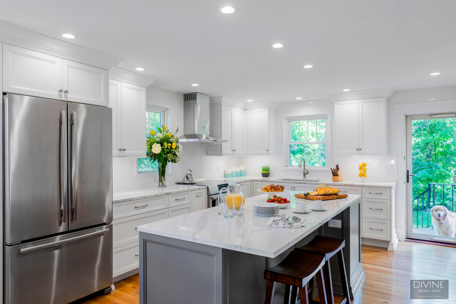  White and grey transitional style kitchen with shaker cabinets and stainless steel appliances. beveled subway tile backsplash in white. 