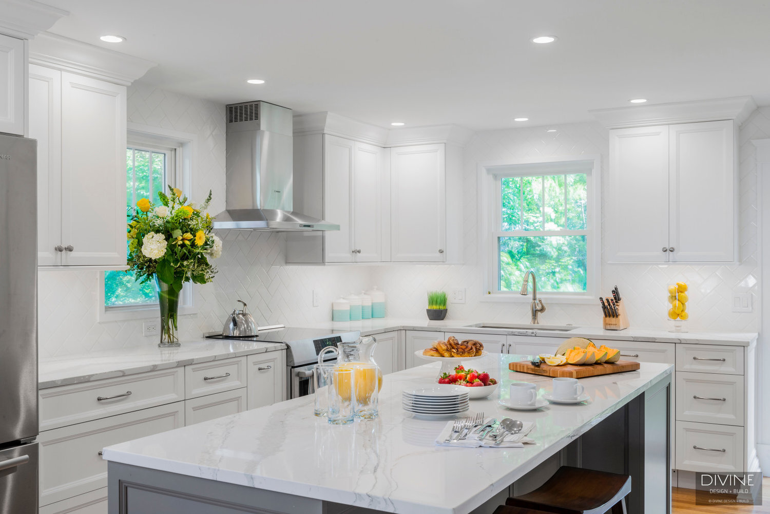  White and grey transitional style kitchen with shaker cabinets and stainless steel appliances. beveled subway tile backsplash in white. 