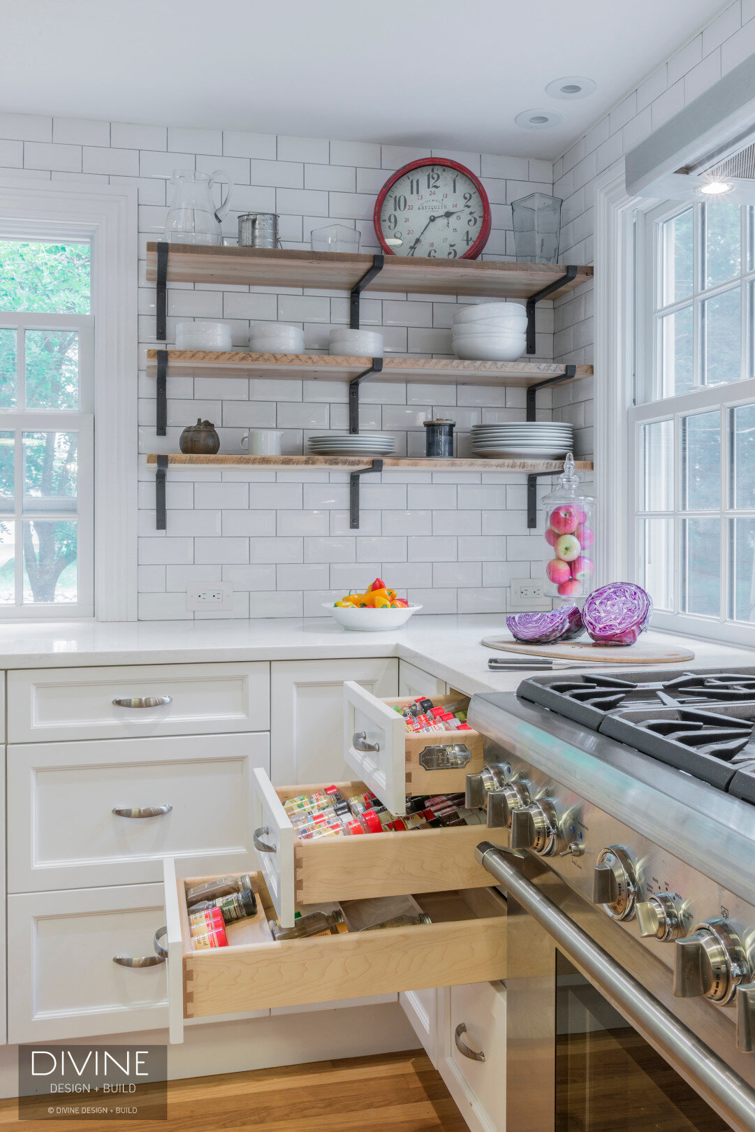 Grey and white transitional style kitchen with shaker cabinets. Interior storage drawer accessories. Creative, hidden and organized spice rack. 