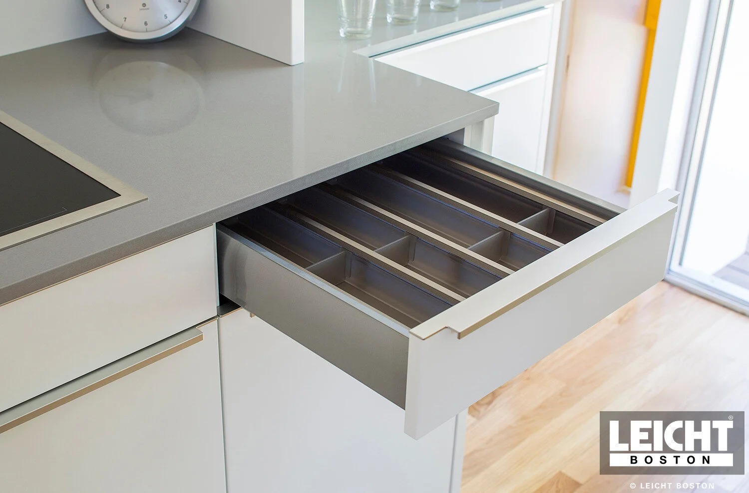  Leicht modern kitchen with Gaggenau appliances and cambria brittanica countertop. Handleless white cabinets with grey channels. Open shelving. Interior drawer accessories.
