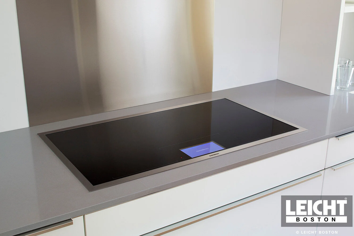  Leicht modern kitchen with Gaggenau induction cooktop and appliances and cambria brittanica countertop. Handleless white cabinets with grey channels. Open shelving. 