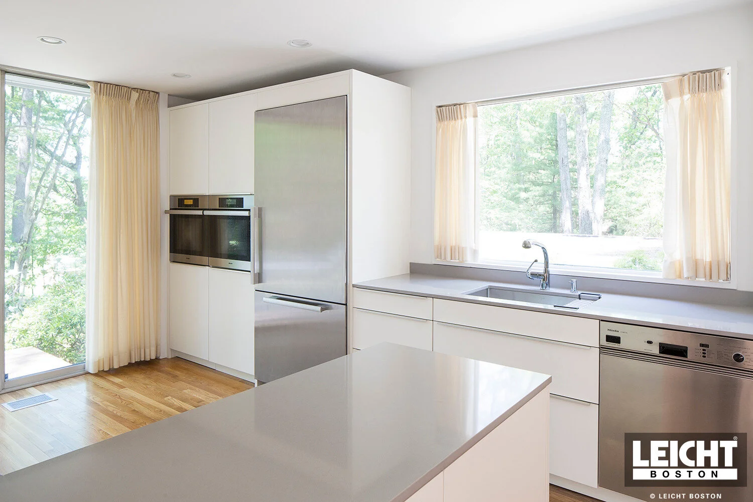  Leicht modern kitchen with Gaggenau appliances and cambria brittanica countertop. Handleless white cabinets with grey channels. Open shelving. 