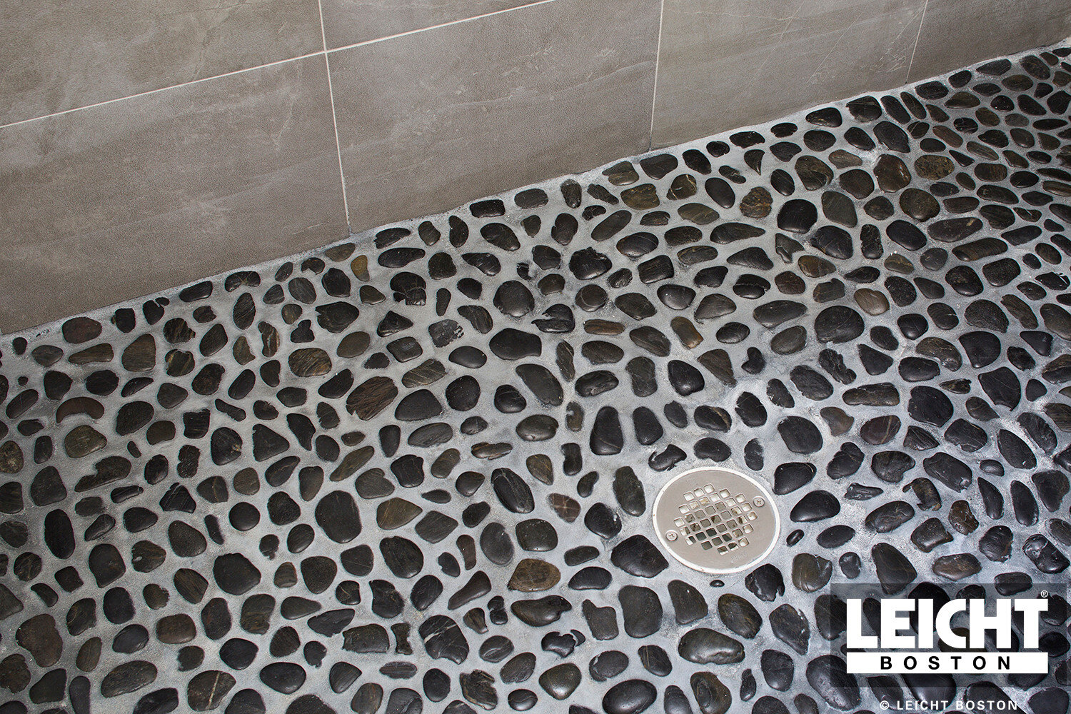  natural stone mosaic shower floor with modern grey stone walls