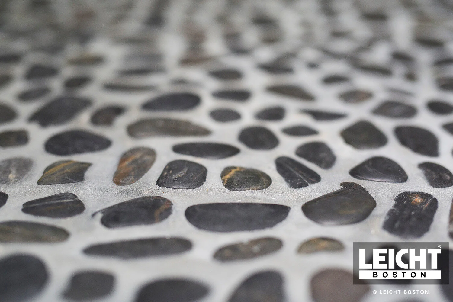  natural stone mosaic shower floor with modern grey stone walls