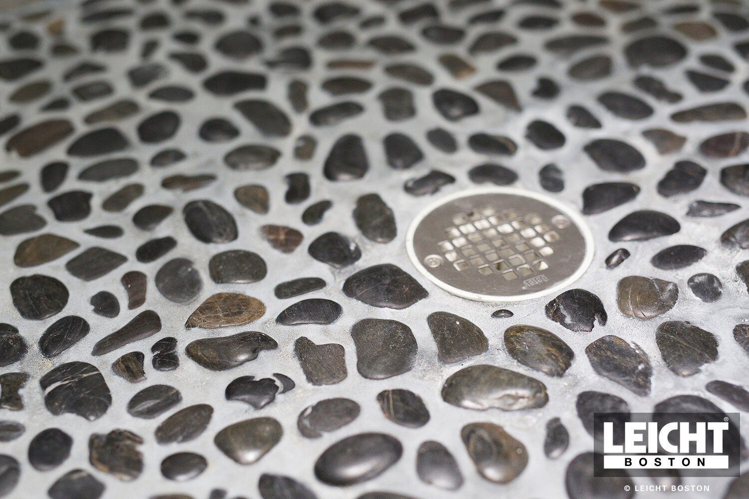  natural stone mosaic shower floor with modern grey stone walls