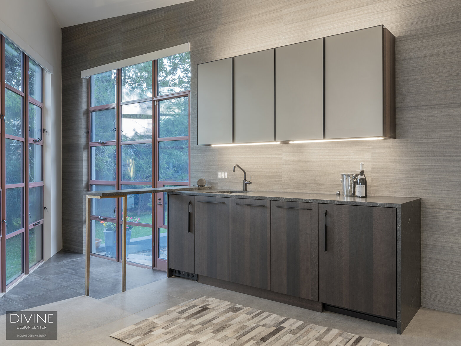  Modern Leicht, grey wet bar with converging glass windows, floating upper cabinets, textured grey wood lower cabinets and undercabinet lighting illuminate the space.  