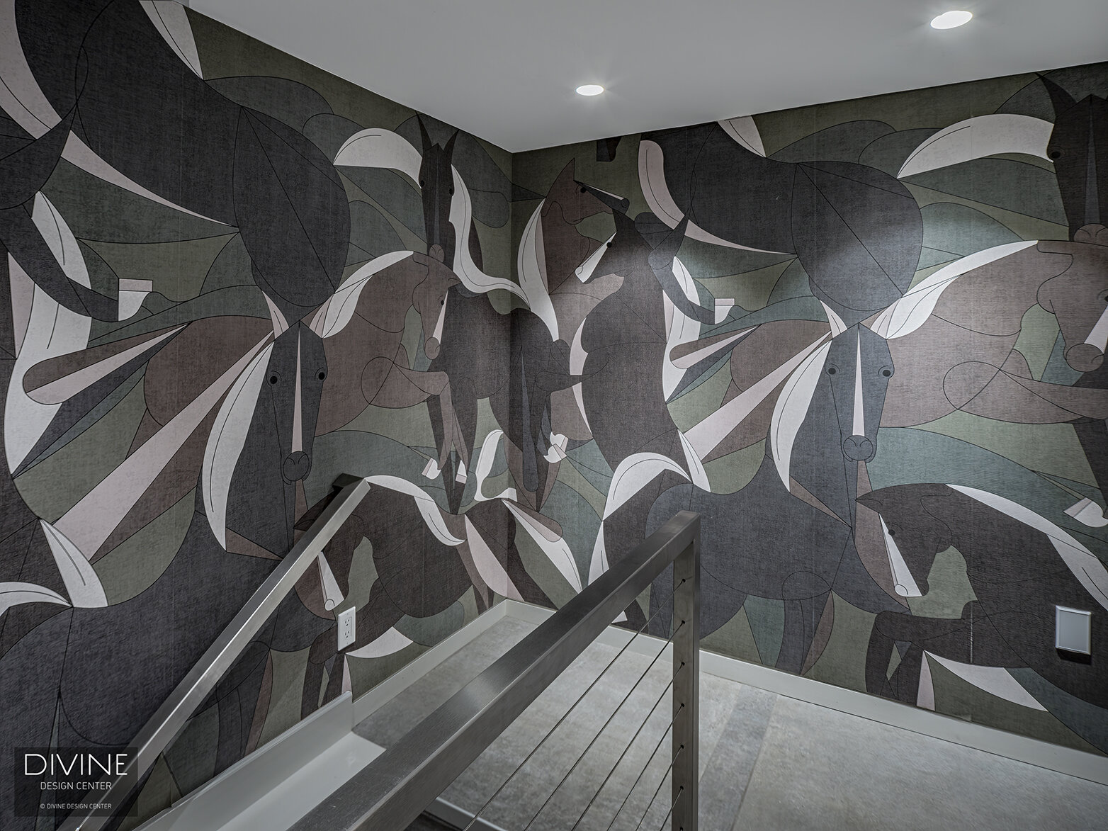  Modern wallpaper in dark charcoals, soft greens, and poignant whites by London Art wrap the hallway staircase. Overhead, recessed lighting and concrete floors finish the space.  