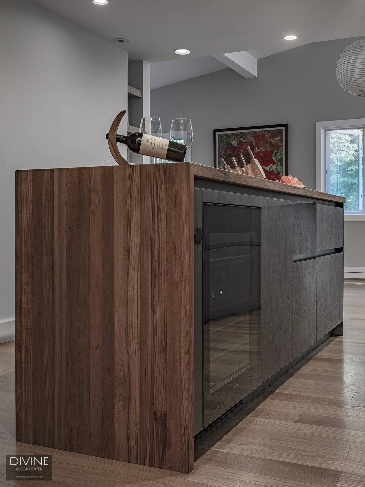  modern, black leicht kitchen with black miele appliances, a wine refrigerator and an appliance garage. Exposed brick backsplash and concrete countertops.  