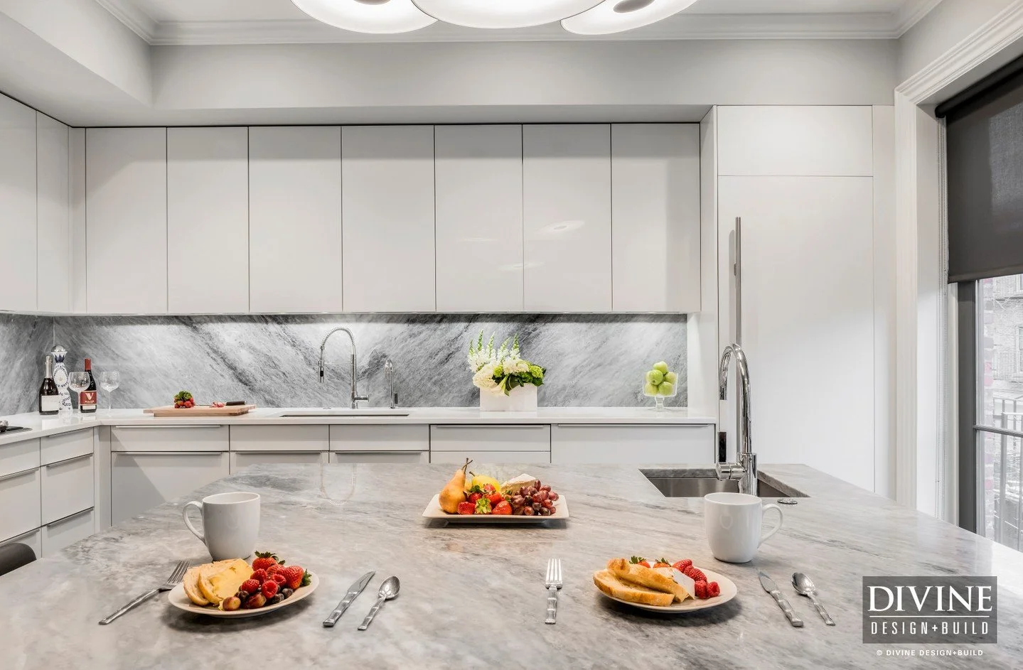 Bright, sleek, and quietly luxurious &mdash; this contemporary kitchen reimagines a classic South End Victorian with a modern European perspective. Gloss white slab cabinetry, integrated handles, and hidden appliances create a seamless architectural 