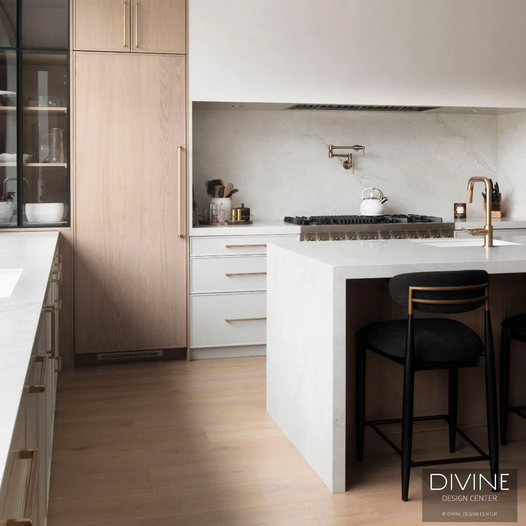 Natural oak meets crisp white lacquer in this double-island kitchen outside Boston. Panel-ready @jennair appliances, brushed brass hardware, and a glass-framed bar area &mdash; every detail considered by Divine Custom Line. 🤍

🔨 Special Thanks: @cu