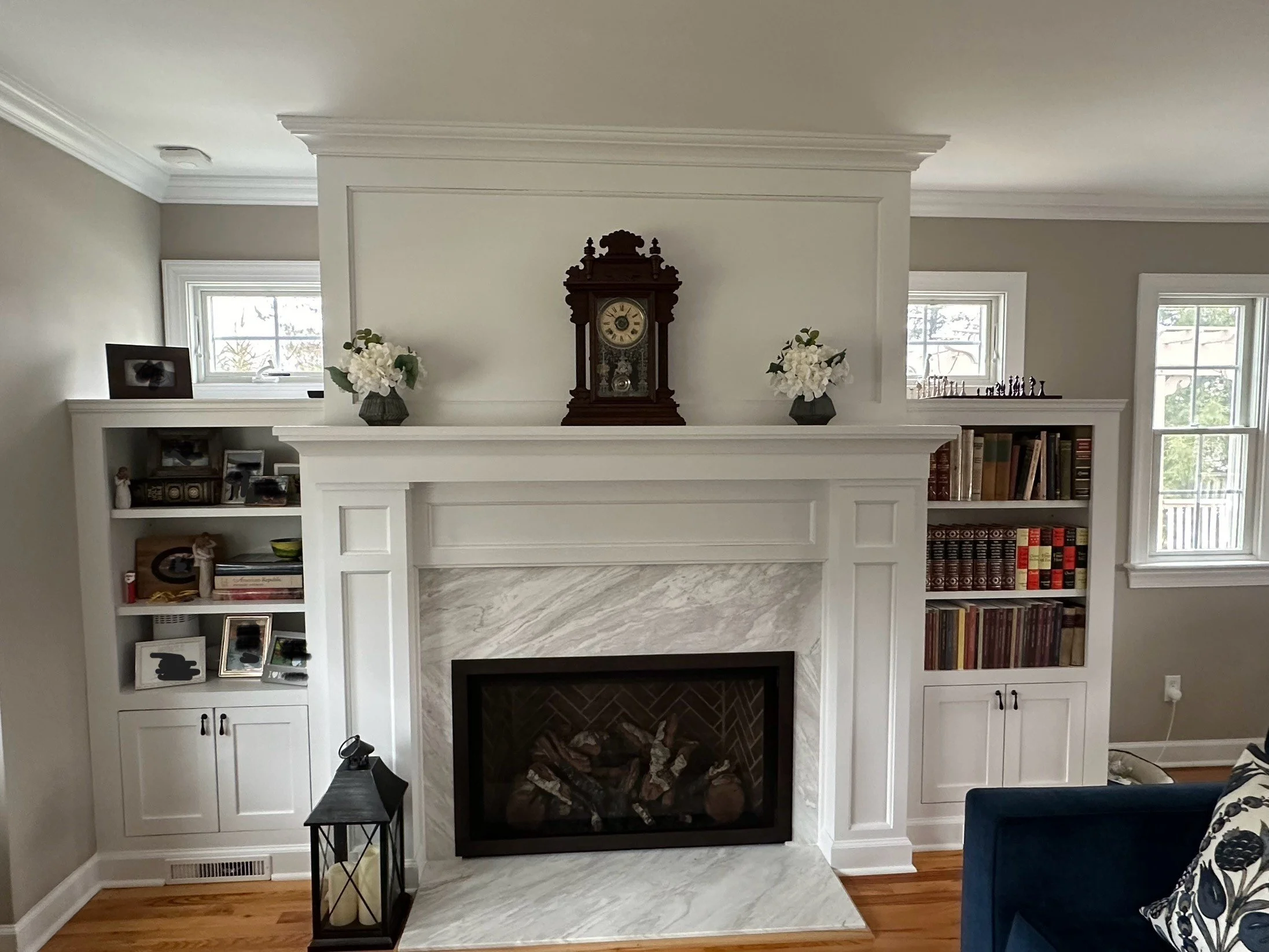 These custom cabinets were designed to complement the fireplace. The windows provide natural light and a pretty backdrop for the new gas fireplace. 
