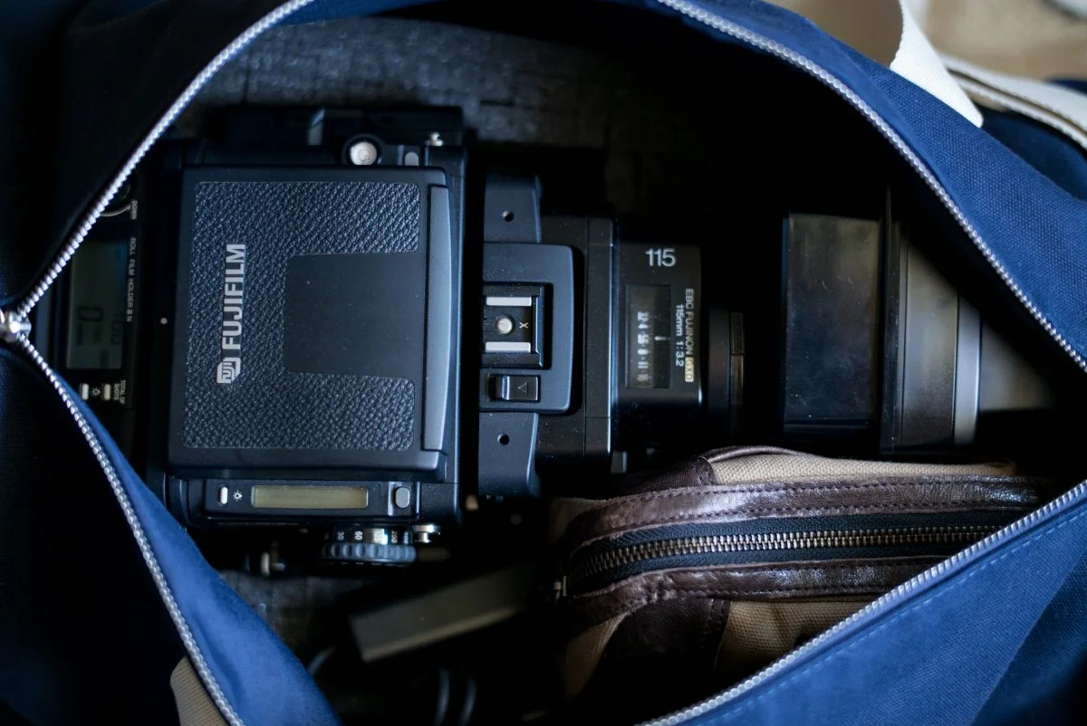 The GX680IIIS placed into a Pelican case foam insert inside of a duffle bag which also contains a bag of 120 roll film, a remote trigger and an additional lens