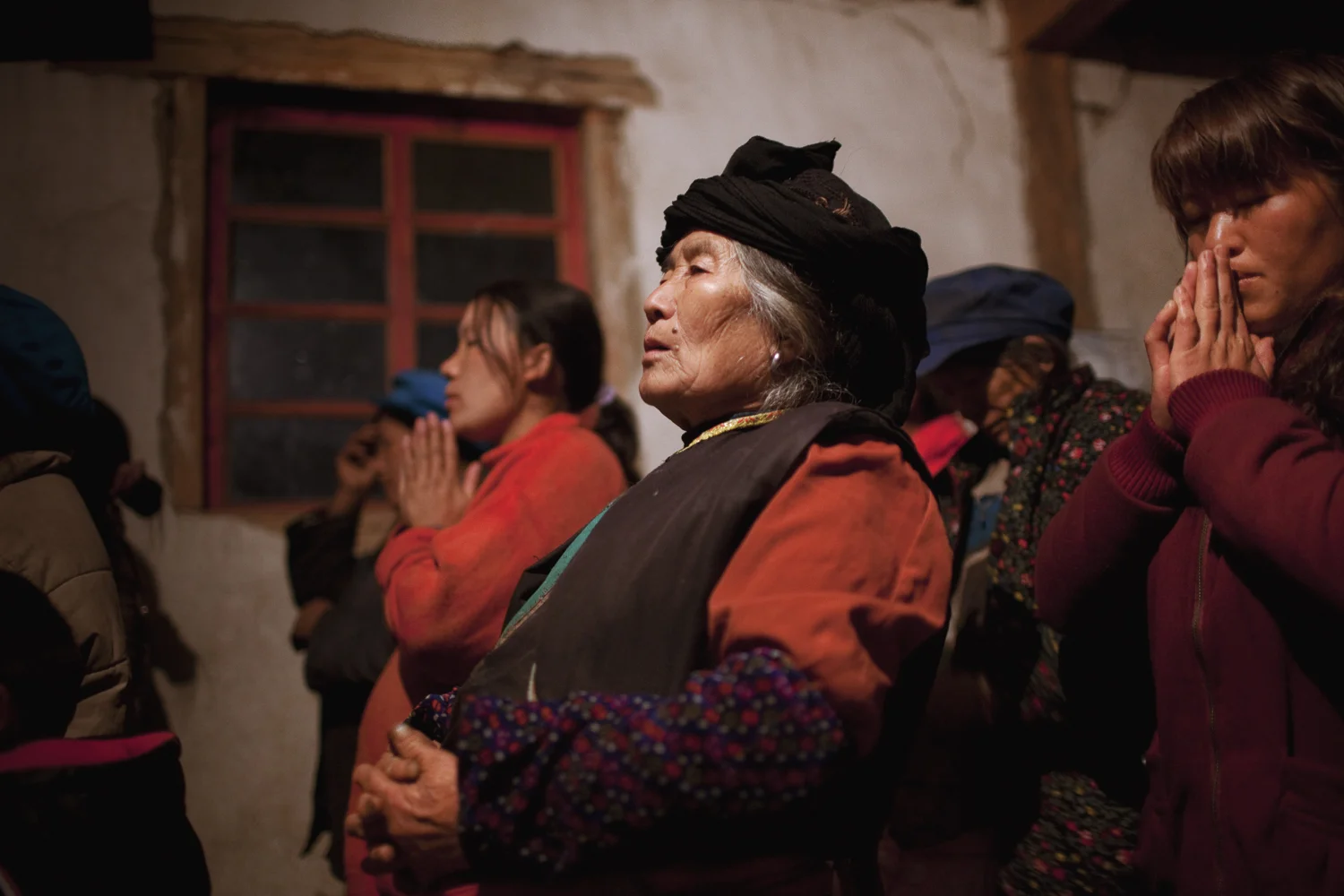 Qiunatong Village, Yunnan. Most of the minority groups converted to Christianity a hundred years ago when missionaries crossed over from Burma. Villagers gather for a late night mass on New Year's Eve. 