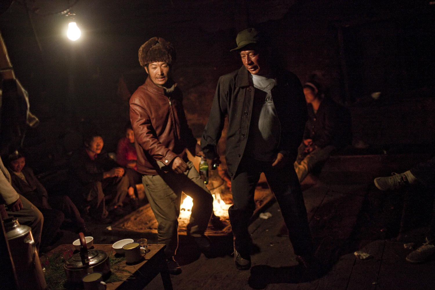  Qiunatong Village, Yunnan.&nbsp; Nu villagers gather at a home to drink and dance. At midnight on New Years Eve everyone was supposed to drink spring water but most never made it out of these house parties.&nbsp;&nbsp; 