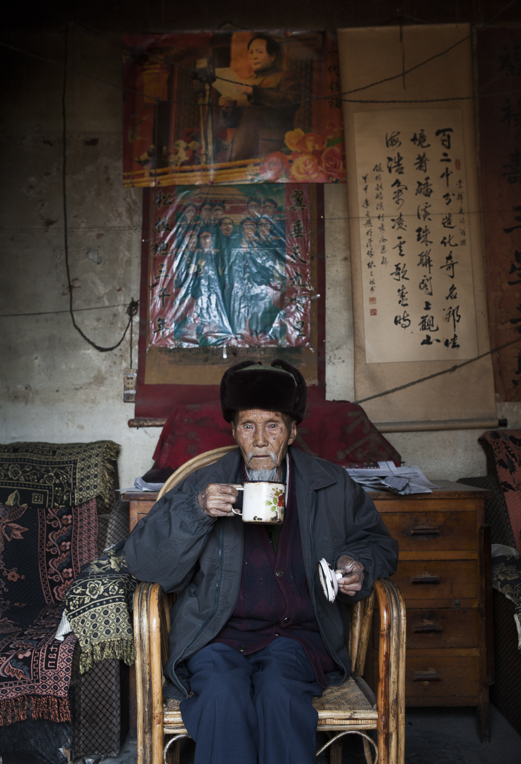  Beipang cun, Yunnan.&nbsp; On the left, a village elder and leader sits for a portait in the local temple.&nbsp; This temple is 160 years old and has never been renovated.&nbsp; On the right, a detail shot of the temple's entry way.&nbsp; 