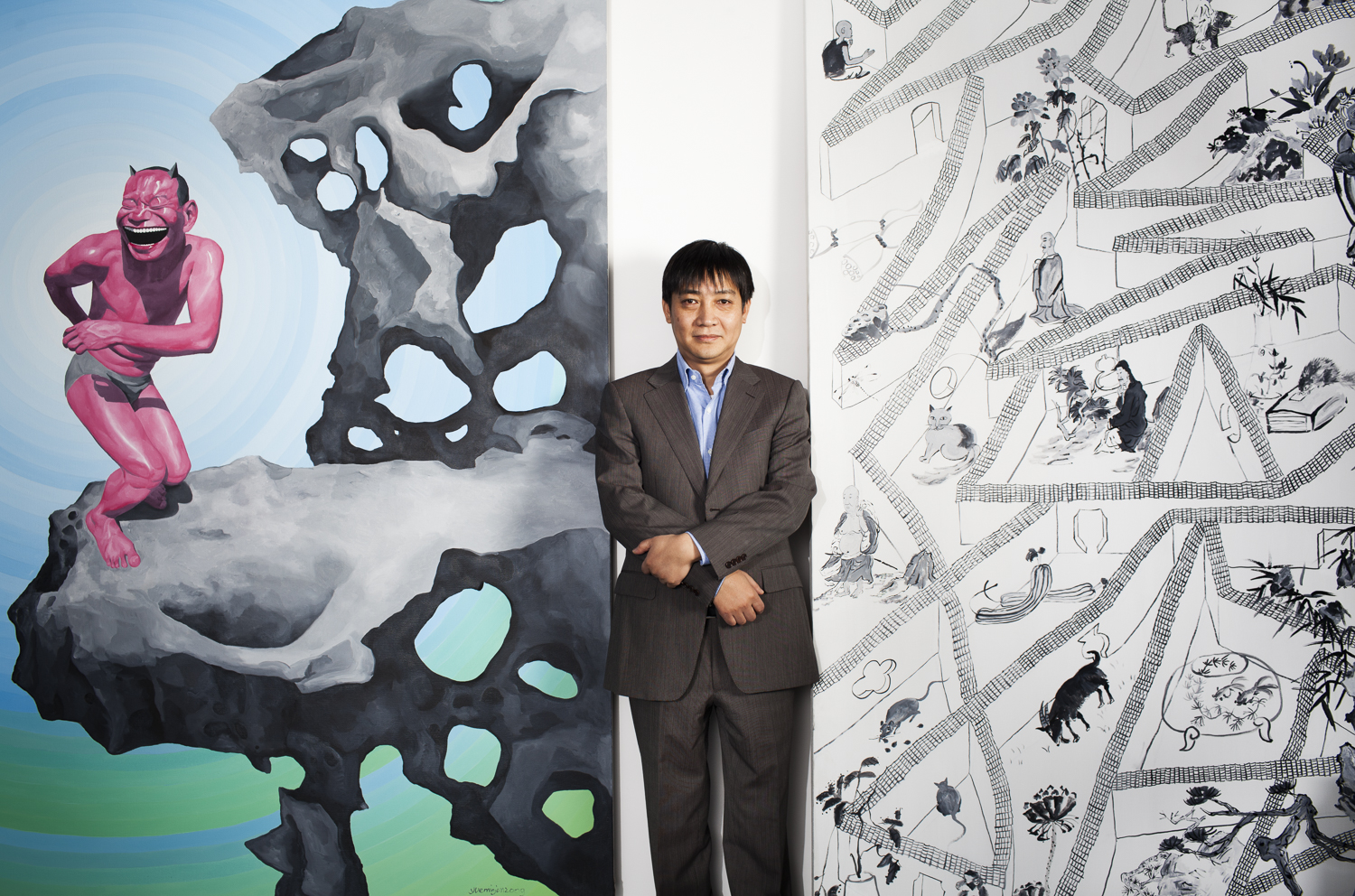  Leng Lin, Gallery President of Pace Beijing in in between two paintings by Yue Min Jun 