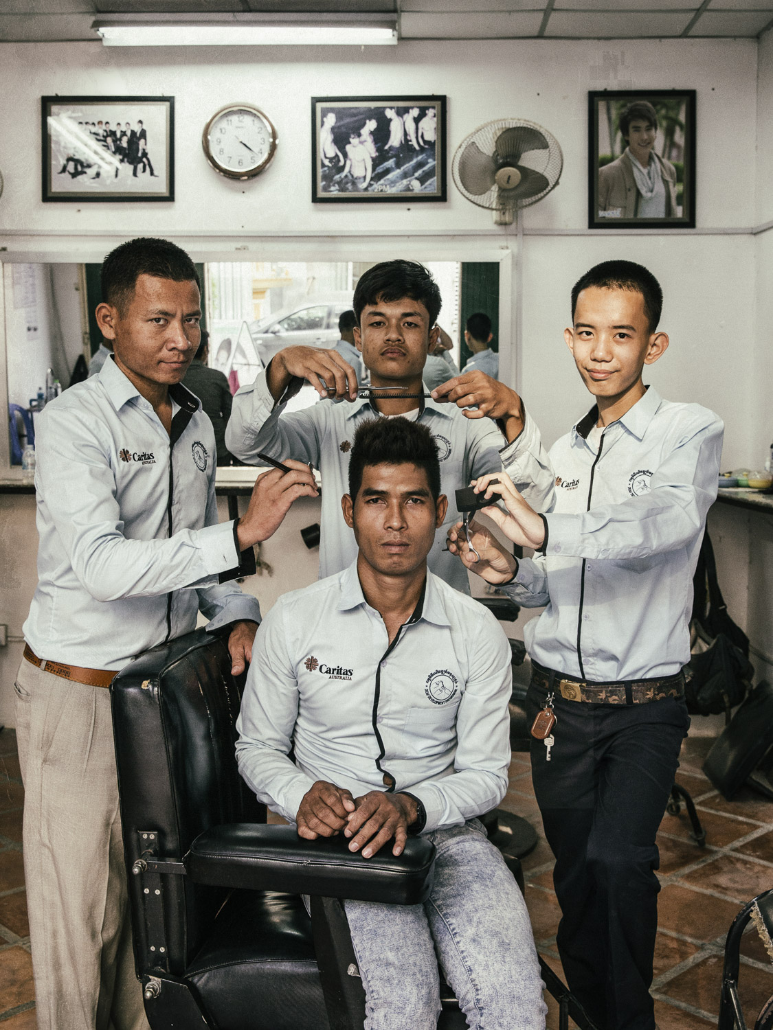  Deaf students at the barber vocational school located in the bottom floor of DDP's Phnom Penh center. Local people often use the services of the barbers at the training center which doubles as a barbershop. 