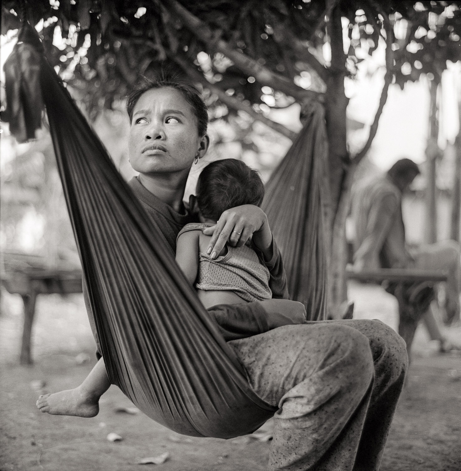 Is a 23 year old woman named Nena. She lives in rural Cambodia outside the city of Kampot. She lives with her mother and son. Having never participated in formal education where she could learn Cambodian Sign Language, Nena relies on gestures to communicate with her mother. Nena spends the day caring for her son and helping her mother with chores.