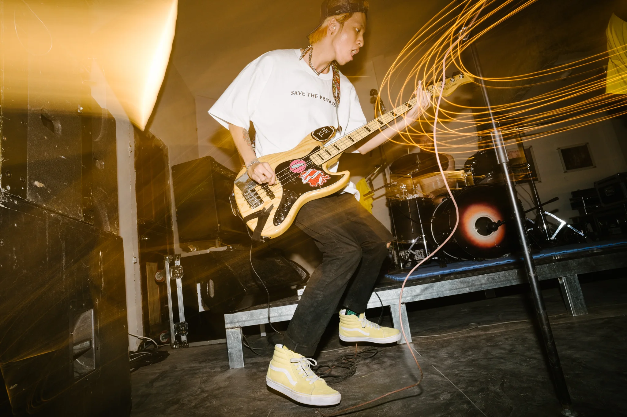 Local punk act 7UPPERCUTS performs in Ho Chi Minh City. Man plays the bass on stage. Punk show documented by Lee Starnes.
