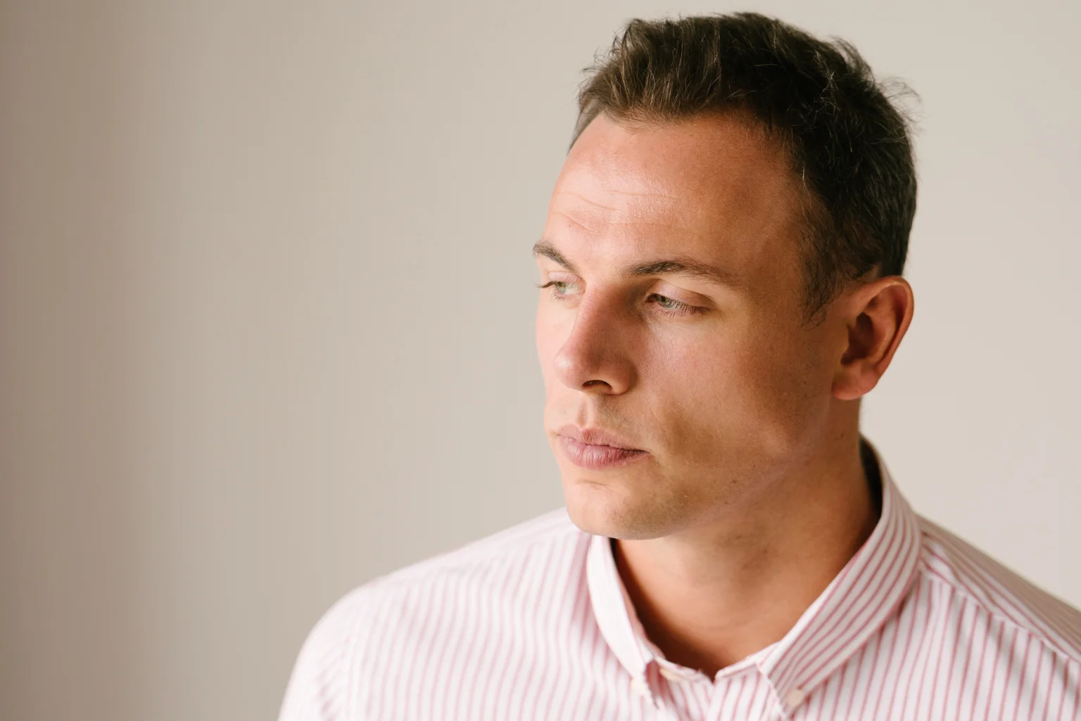 Matthew Holland looks away from the camera. Portrait shot by Lee Starnes, Saigon-based photographer for Holland Preconstruction website launch.
