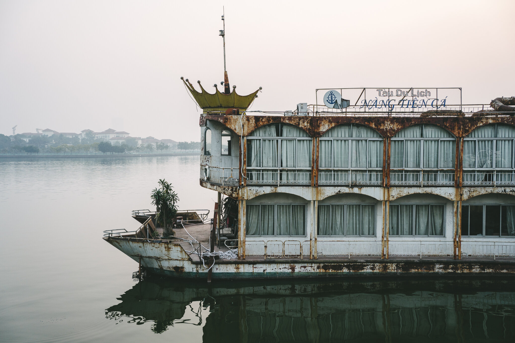 Abandoned yatch-turned-restaurant "The Mermaid" docks at West Lake, Hanoi. Photographed by Lee Starnes, Ho Chi Minh City-based photographer.