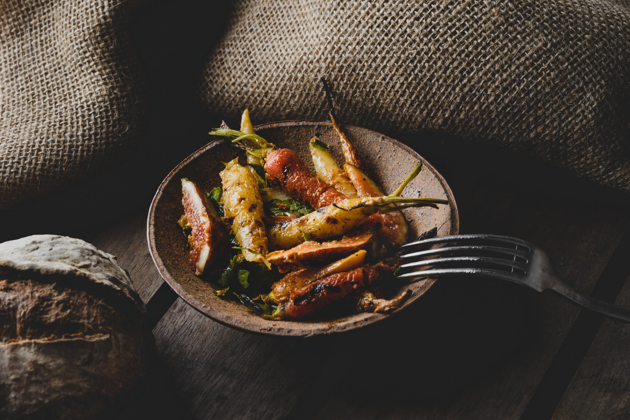 Roasted Carrots with figs, fresh herbs, and sourdough bread from  Ho chi minh city restaurant, Quince. Shot by Lee Starnes, Vietnam food photographer.