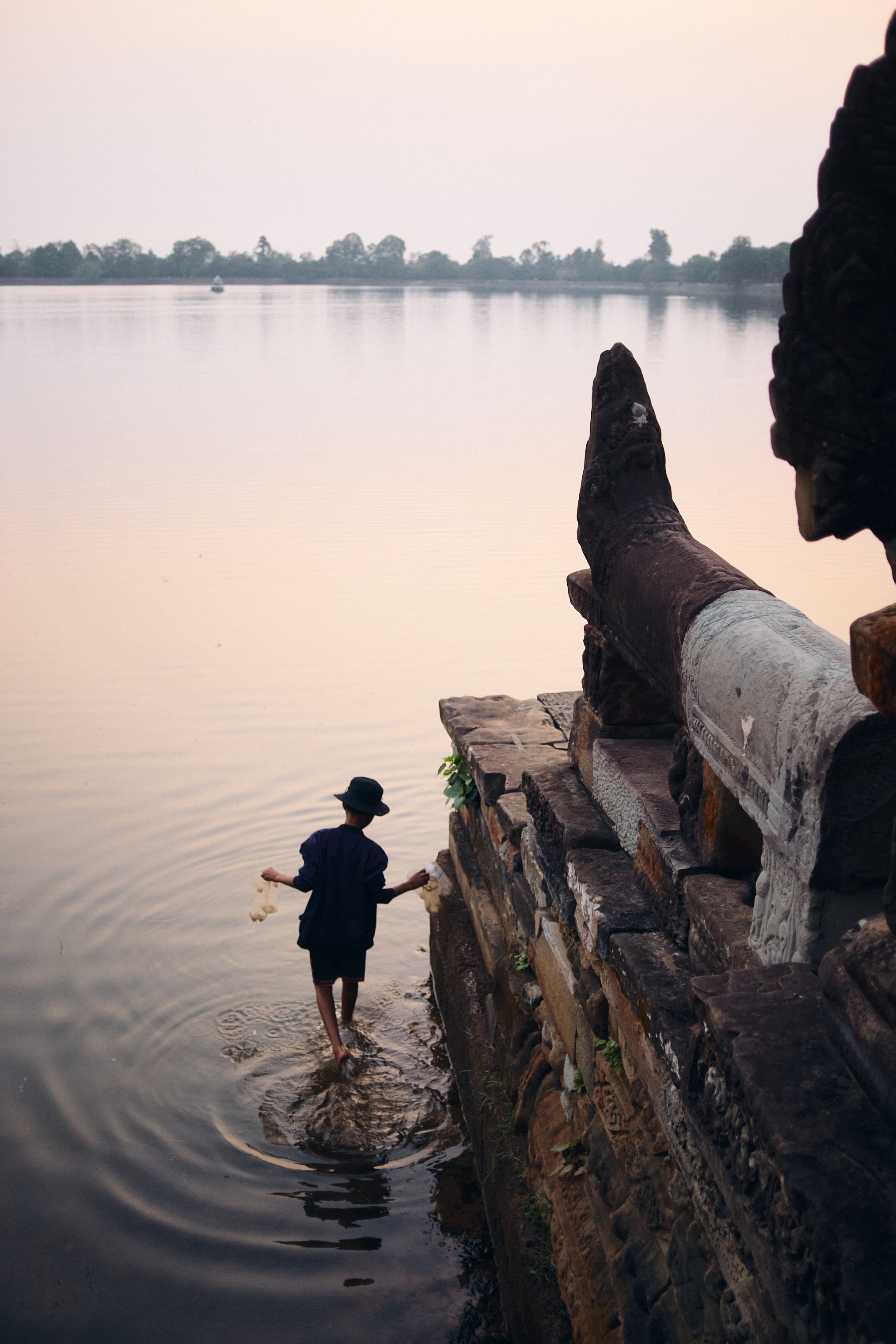 A barefoot local walking towards a lake in Cambodia. Image by Lee Starnes, Vietnam travel and product photographer.