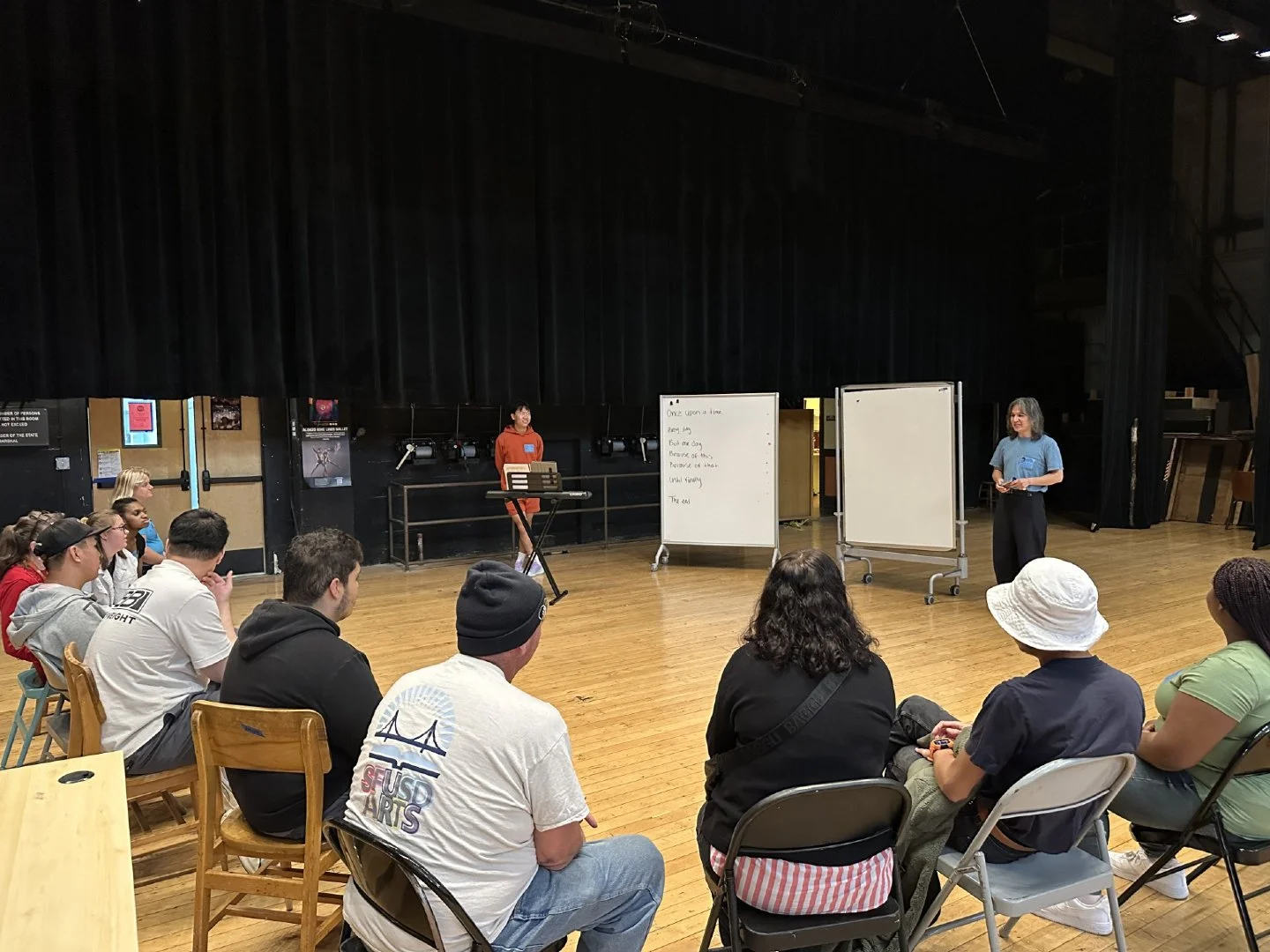 Photo of @gloryoung (left, orange sweatshirt) &mdash; AOP Opera Lab composer &amp; Program Associate &mdash; and @josealbawrites (right, blue shirt) &mdash; Opera Lab librettist, sharing their work-in-progress at @sfoperaguild 's Book to Bravo!/Voice