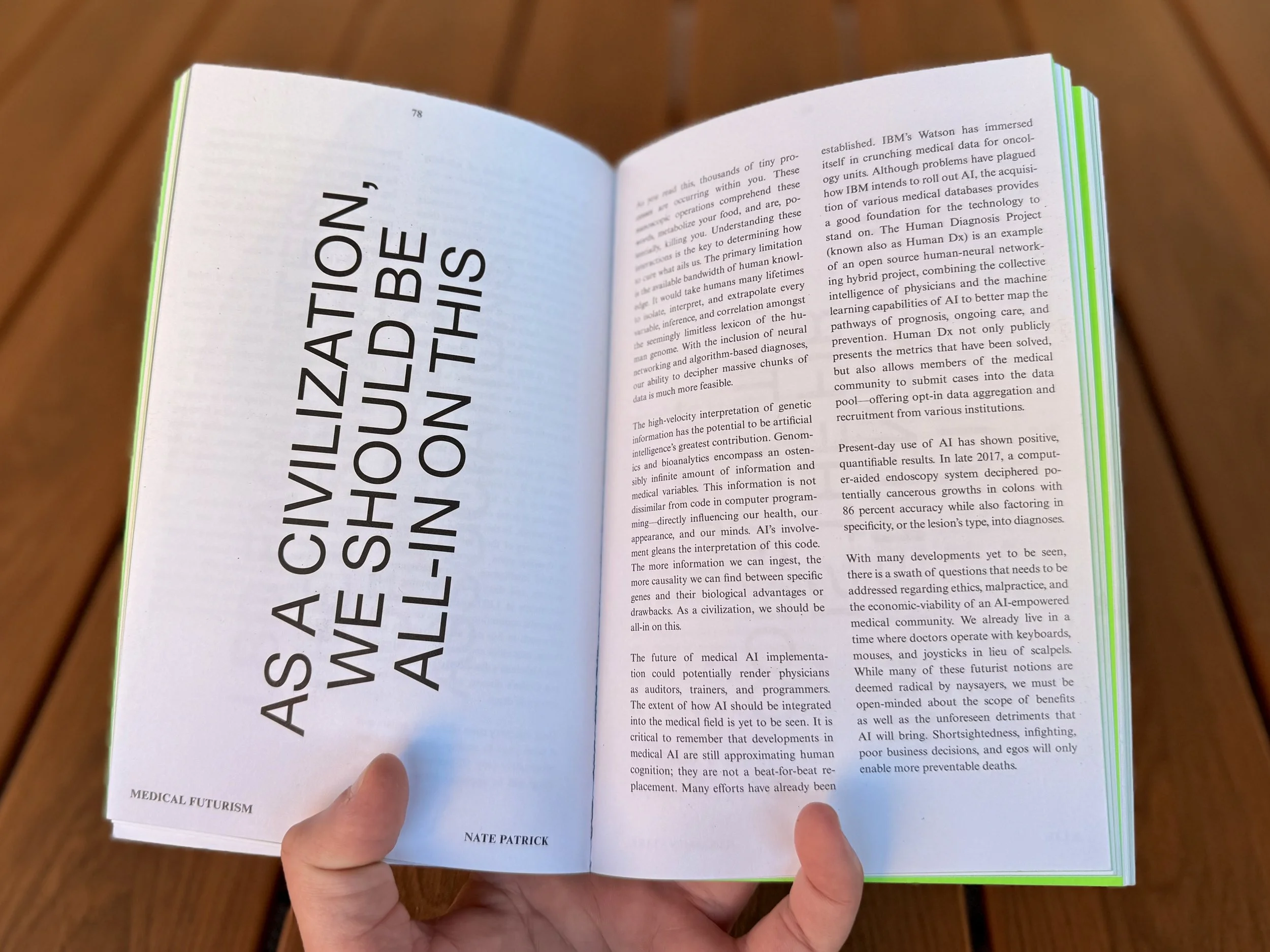 Open book held in hand with the title 'As a Civilization, We Should Be All-In on This' by Nate Patrick, with text on the pages discussing medical futurism and artificial intelligence.