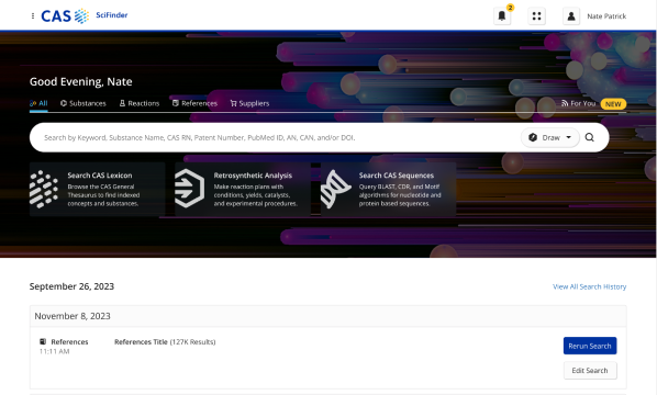 Screenshot of a scientific research database interface with a personalized greeting 'Good Evening, Nate' and navigation tabs for 'All,' 'Substances,' 'Reactions,' 'References,' and 'Suppliers.' The search bar is set to search by keyword, substance name, CAS RN, patent number, PubMed ID, AID, CANT, or DOI. The date displayed is September 26, 2023, with recent search history and options.