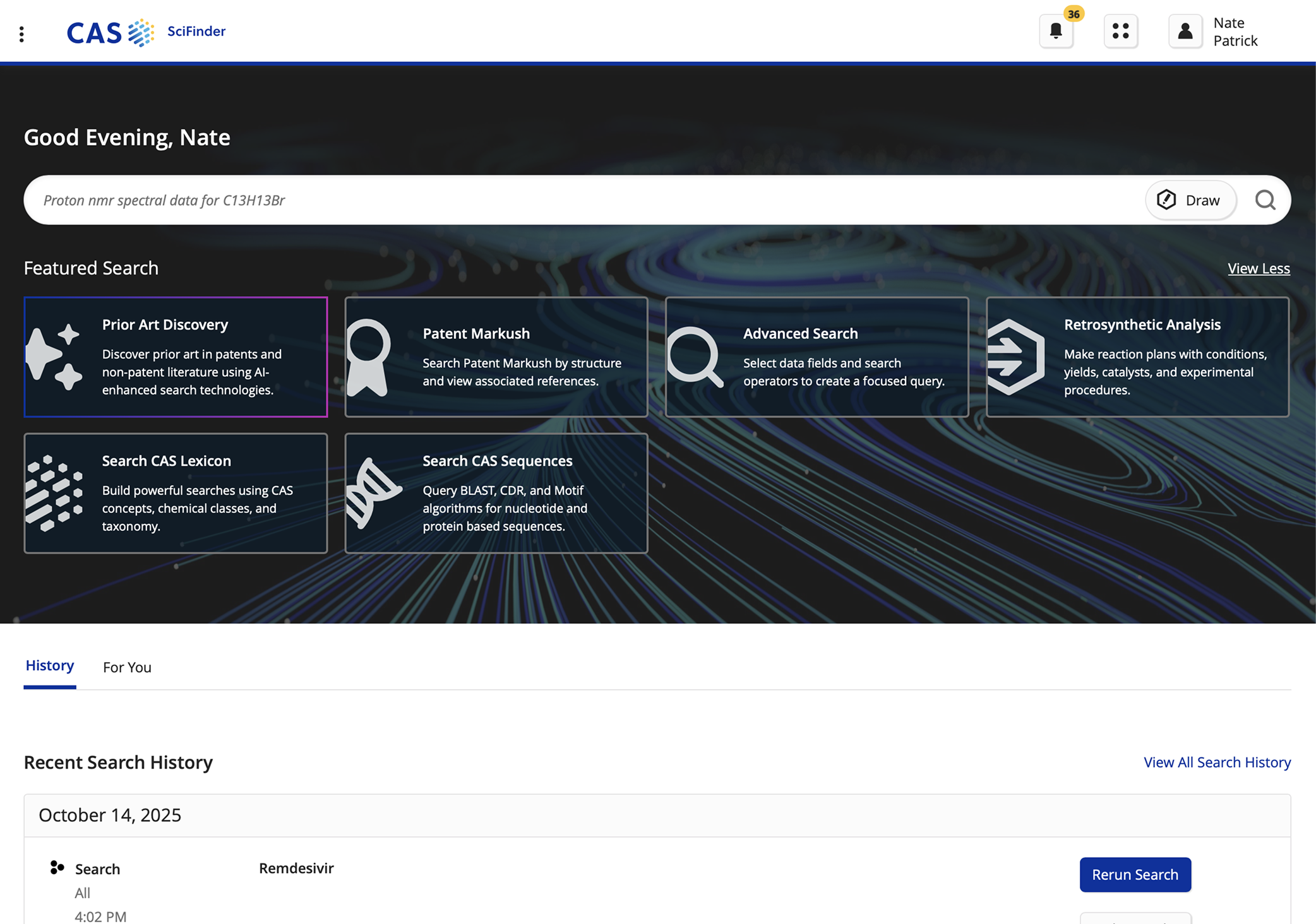 Screenshot of the CAS SciFinder platform featuring a dark-themed interface with molecular pathway graphics in the background. The top shows navigation options with user info and notifications. The main section includes a greeting, a search bar, and a row of feature options for scientific research tools like Prior Art Discovery, Patent Markush, Advanced Search, Retrosynthetic Analysis, Search CAS Lexicon, and Search CAS Sequences. Below, there is a section displaying recent search history with a date and a search for Remdesivir.