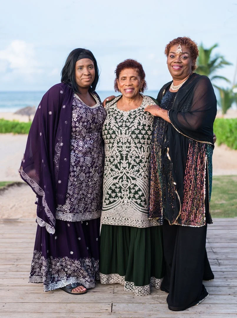 Three generations of black women standing traditional Indian clothing in the Dominican Republic