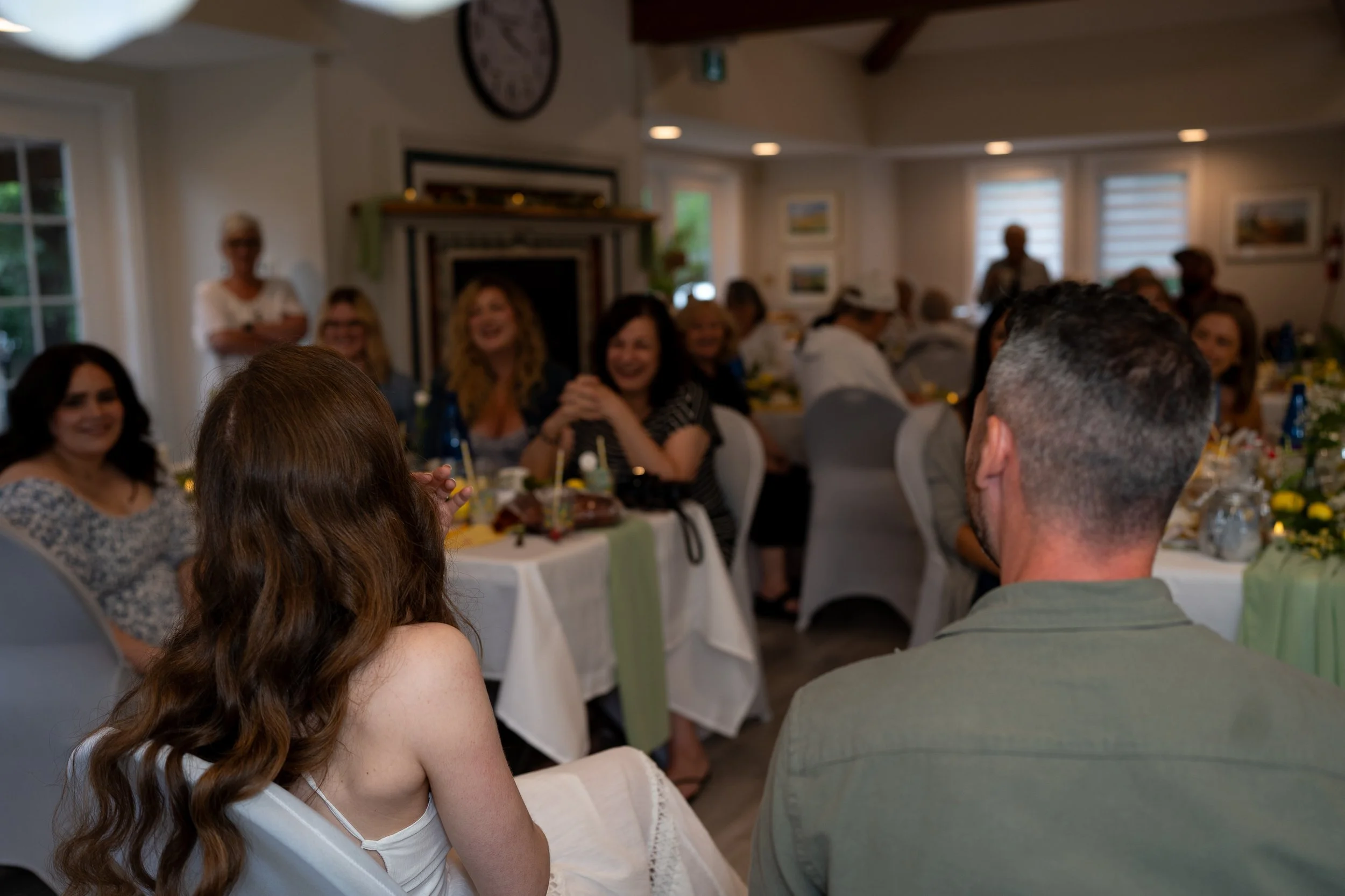 A gathering of people sitting at tables during a bridal shower celebration