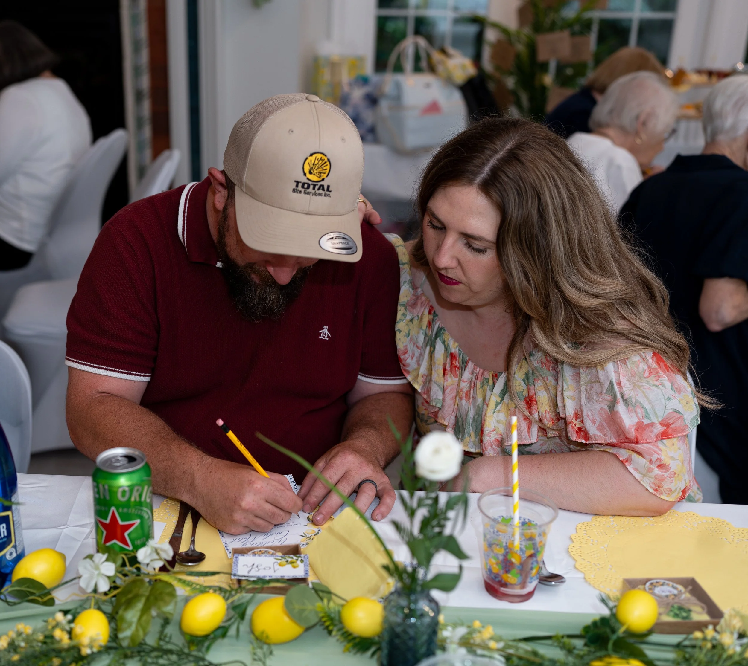 People sitting at a table during a bridal shower celebration.