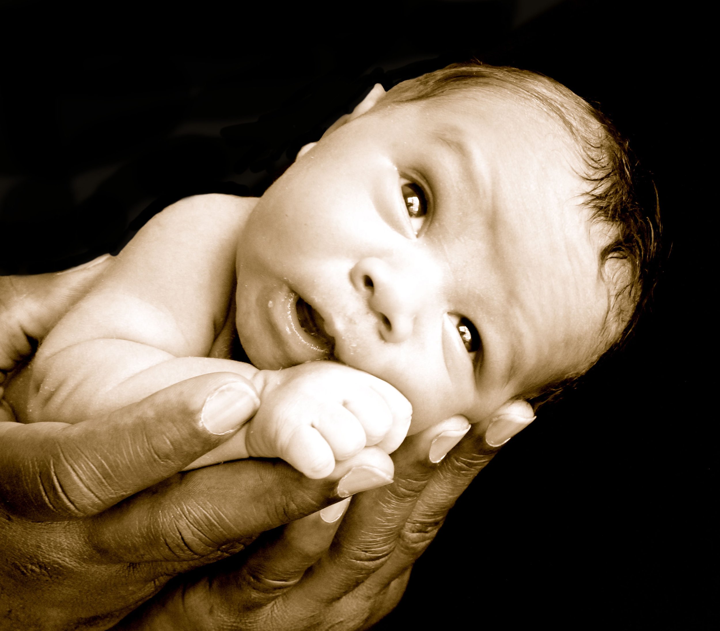 A baby being held in dads hands