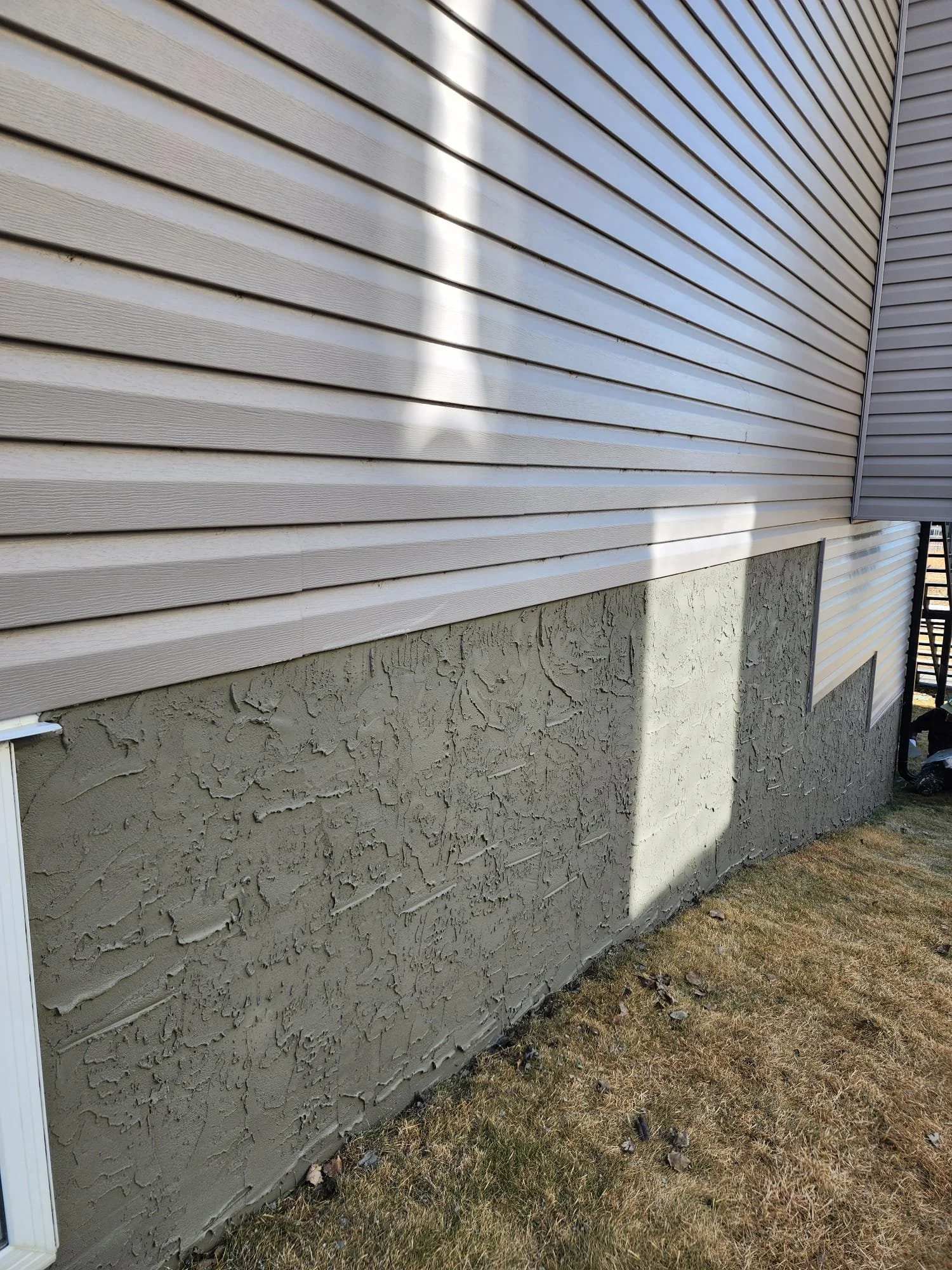 Foundation parging for Calgary home by Uruk Stucco Ltd