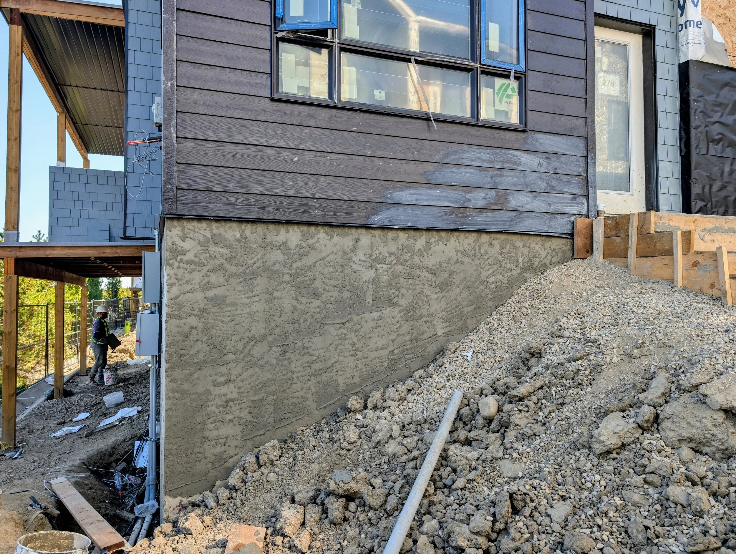 parging below hardie board siding at slokker homes calgary ab