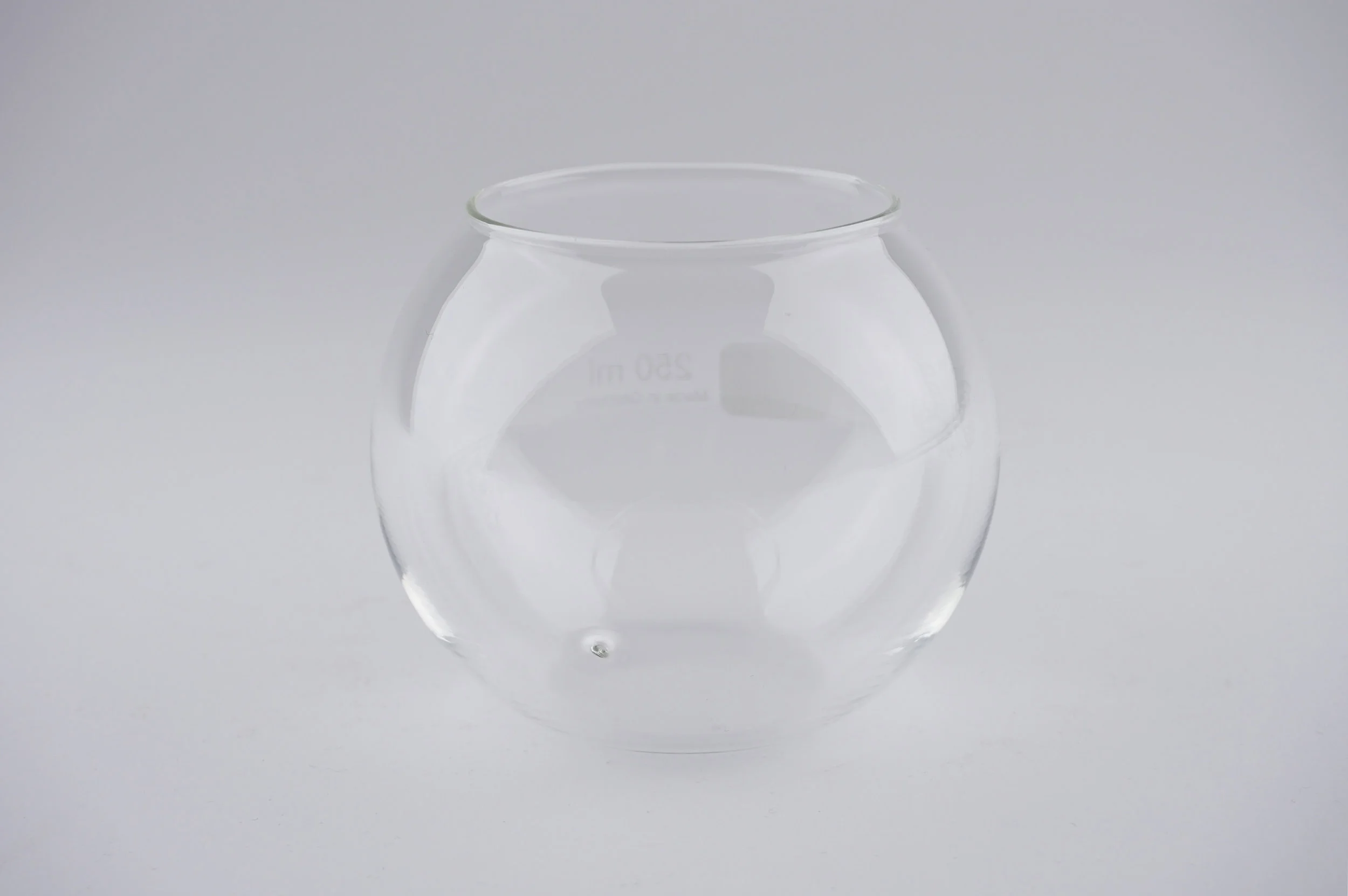 Elizabeth Willing, Pacify , 2018. Laboratory glass with etching and hole, 8 x 8 x 6.5 cm Numbered series, sold in pairs. Image courtesy: Tolarno Galleries.