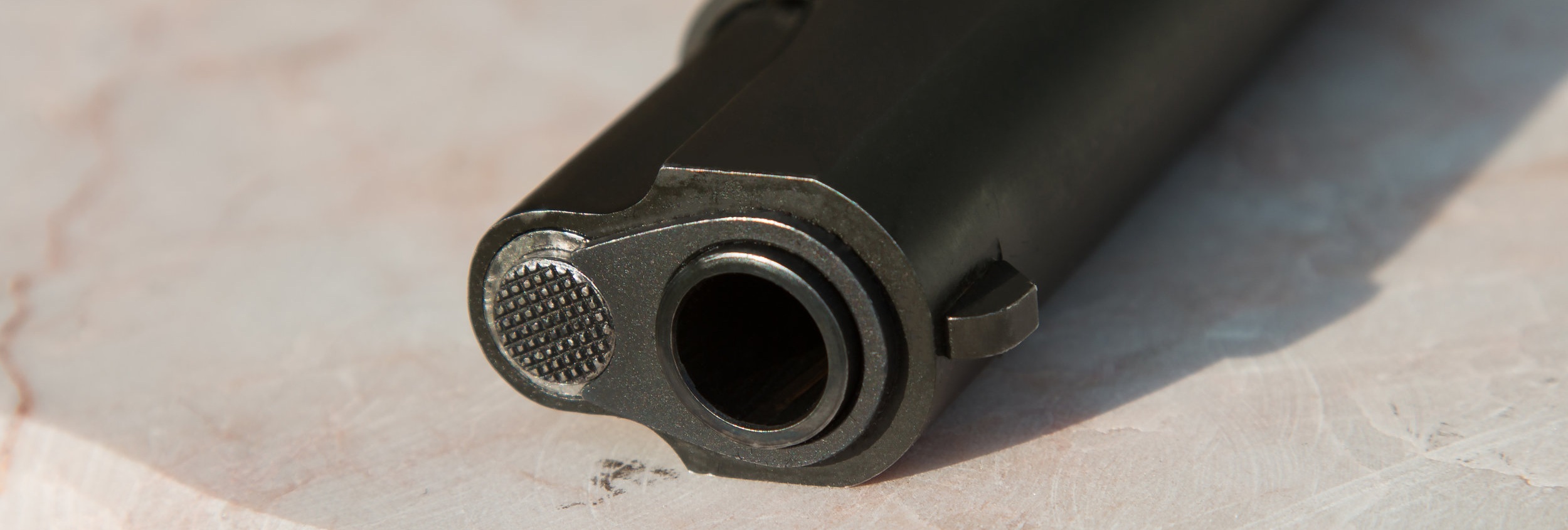 Canva+-+Black+Metal+Gun+on+White+Surface.jpg