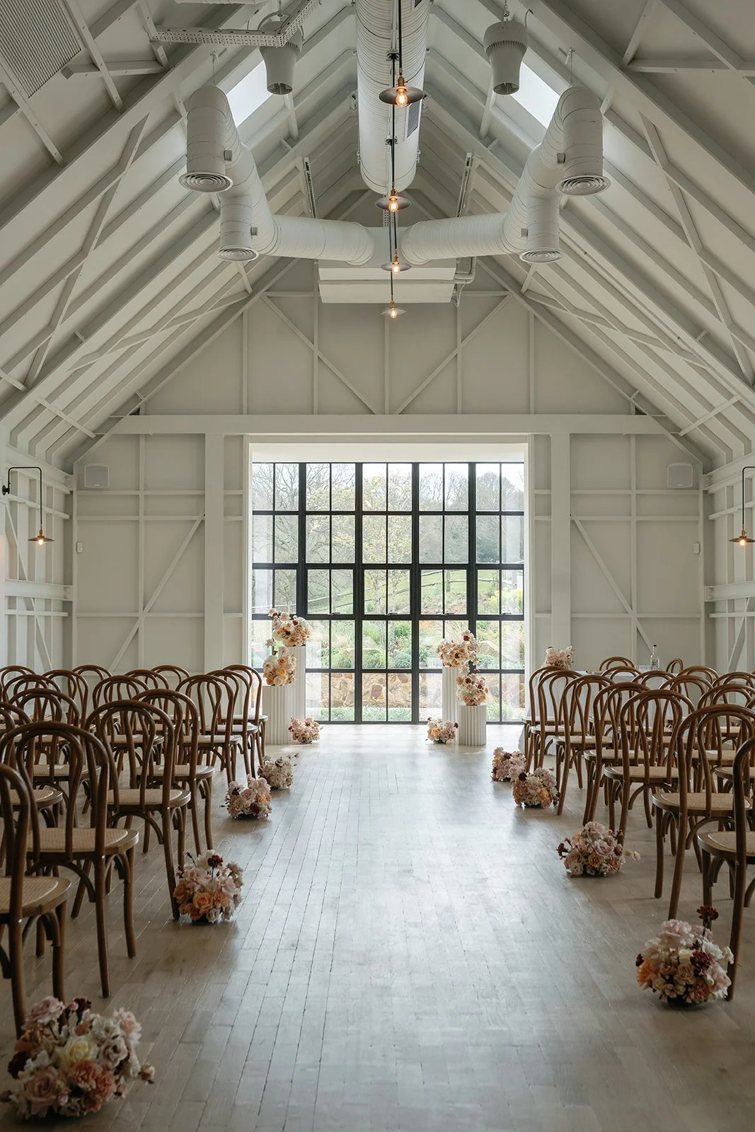 limekiln wedding captured by Laura Vieceliphotography aisle florals cotswold wedding Two Little Birds