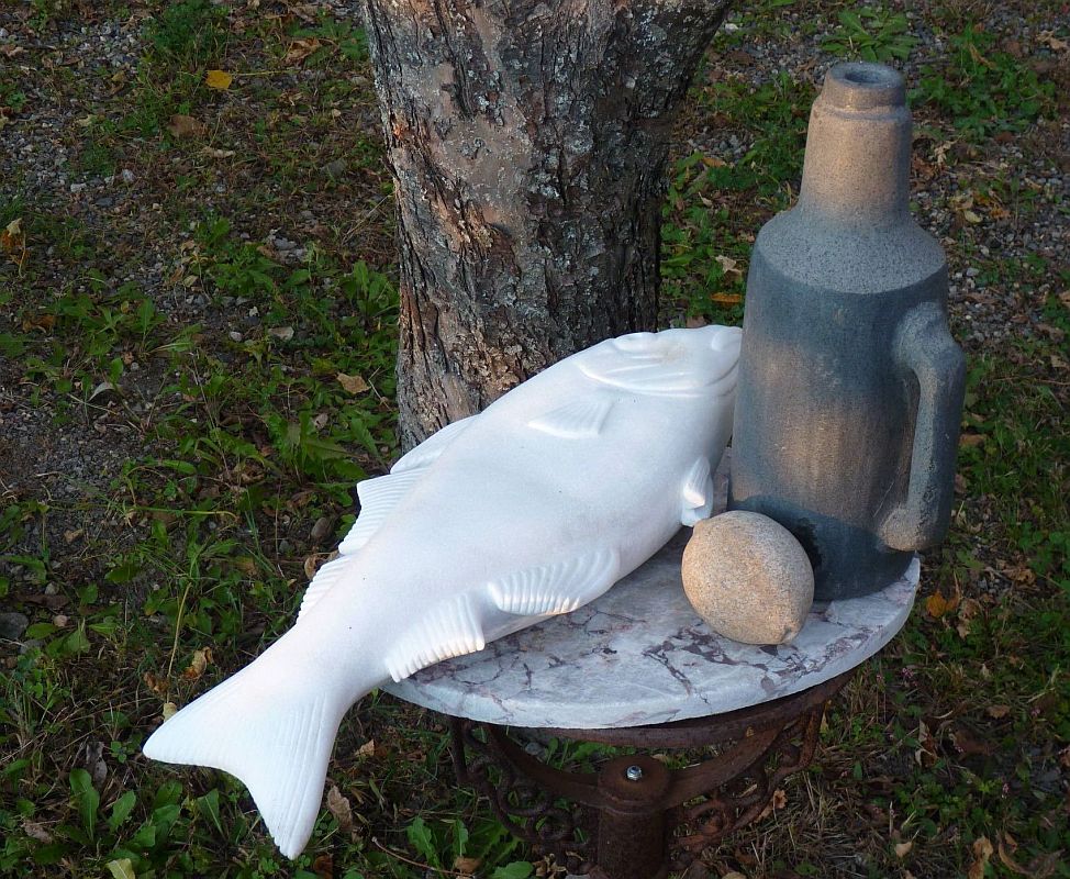  This sculpture consists of a bottle, a lemon and a haddock fish, all carved from various stones. 