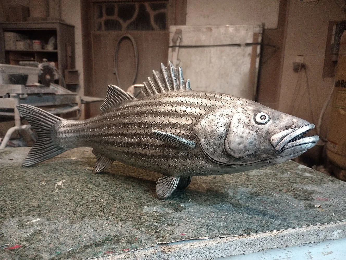  The artist used a mix of traditional and modern patinas to create the life-like appearance of a striped bass.   