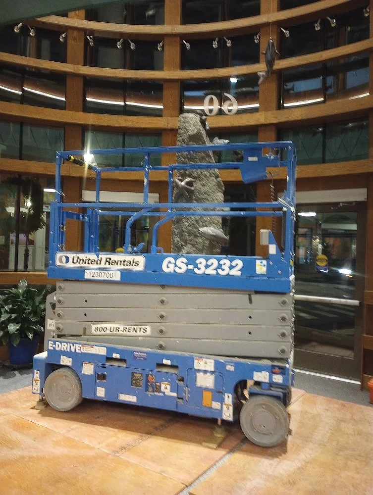 Lift used to reach the ceiling of the foyer to install the nylon cables to hang the striped bass sculptures 