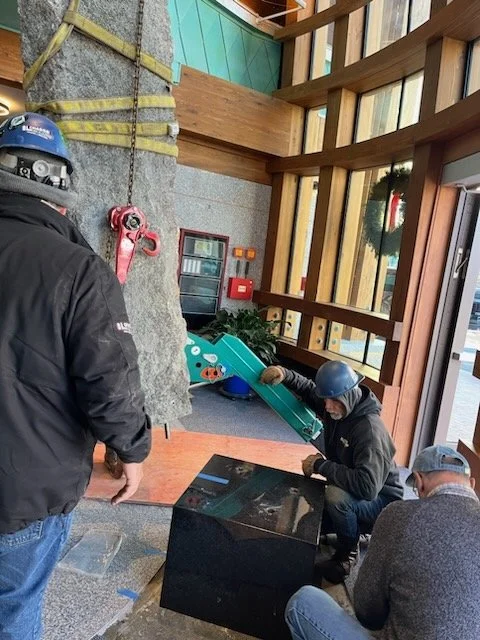  A spider crane was used to set the stone cliff onto its base of polished black granite inside the building 