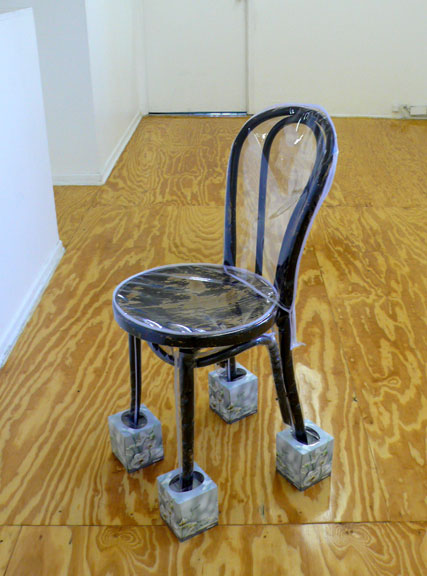  the good shooter’s chair  2008, chair sealed in fitted plastic cover, floral patterned kleenex boxes 