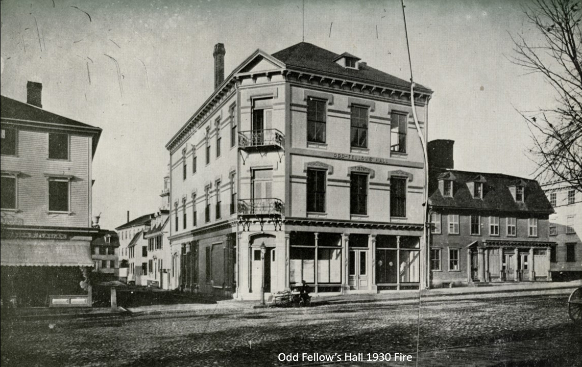 This view on Washington Square, looking north shows the old Odd Fellow’s Hall which stood until 1930. To the left on the other side of Charles Street, is a 3-story store which, in 1925, would be torn down to make way for a bank. Theophilus would have seen this building being constructed.