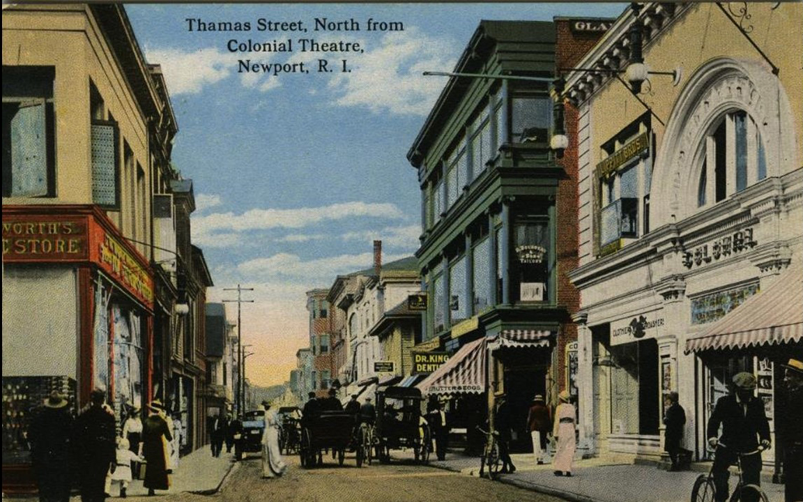 Thames Street looking north in front of the Colonial Theater. Washington Square is 5 buildings up in this photo. The heart, like Washington Square, of the 9th city. “Finally there was, and is, and long will be the NINTH CITY, the American middle-class town, buying and selling, raising its children and burying its dead, with little attention to spare for the eight cities so close to it.”