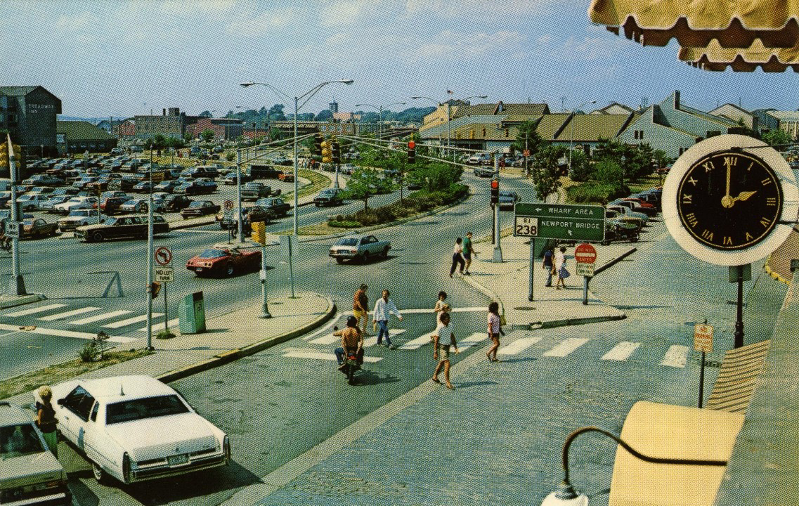  Thames Street at foot of Mill Street looking north. In this photo from the late 1970’s, most everything we see to the left of the clock was “redevelop” land. In the far distance we can see J.T. O’Connell’s lumber yard on Long Wharf (now the Marriott