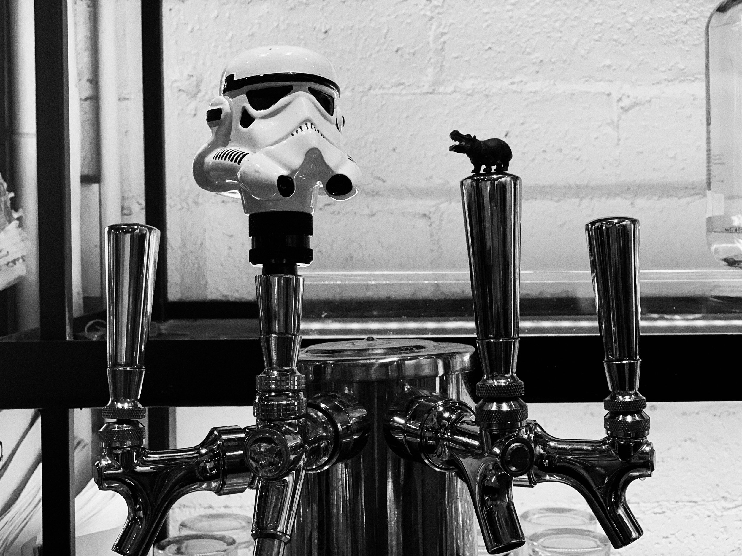 photo of beer tap handles - one topped with a stormtrooper helmet