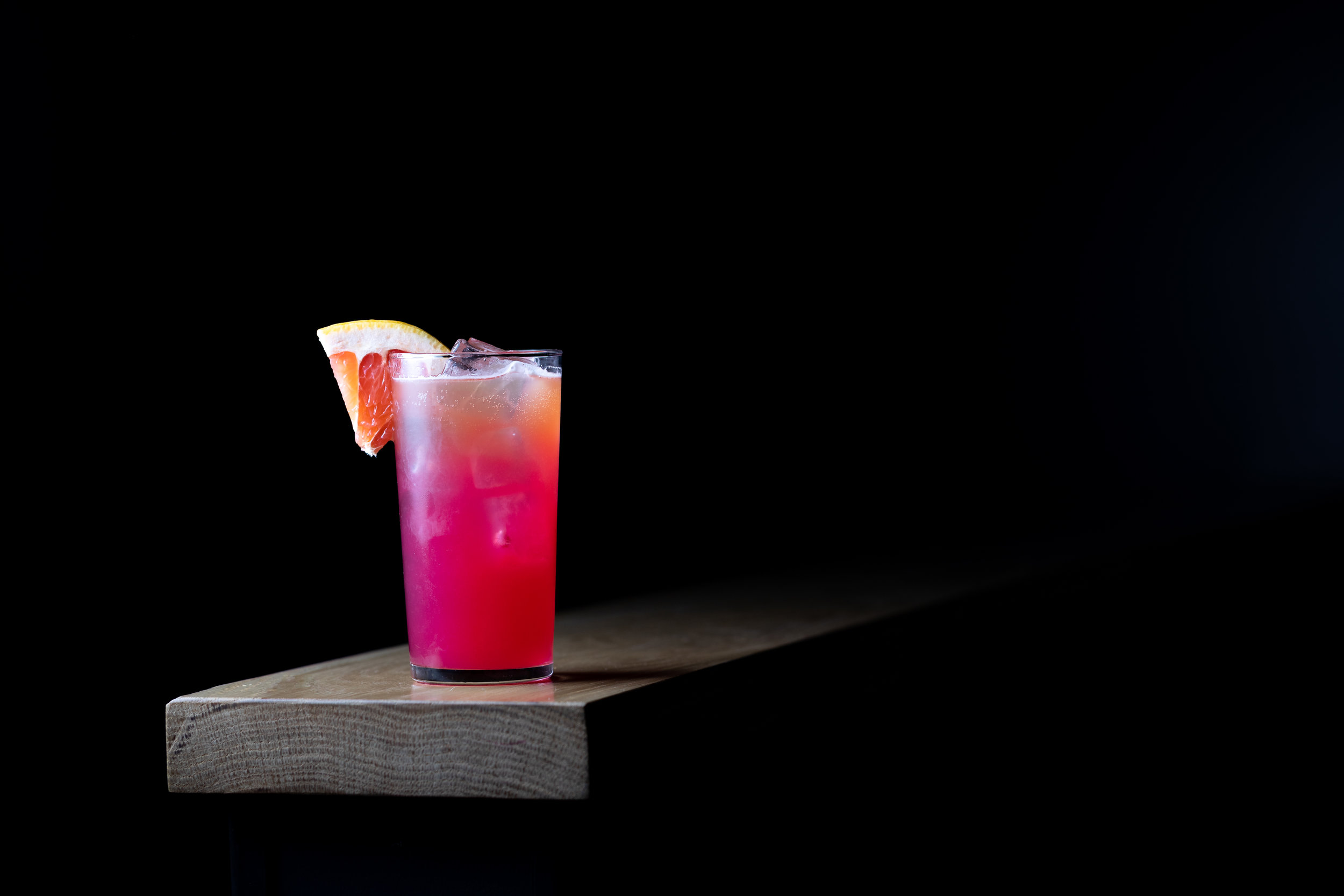 photo of a cocktail garnished with an orange